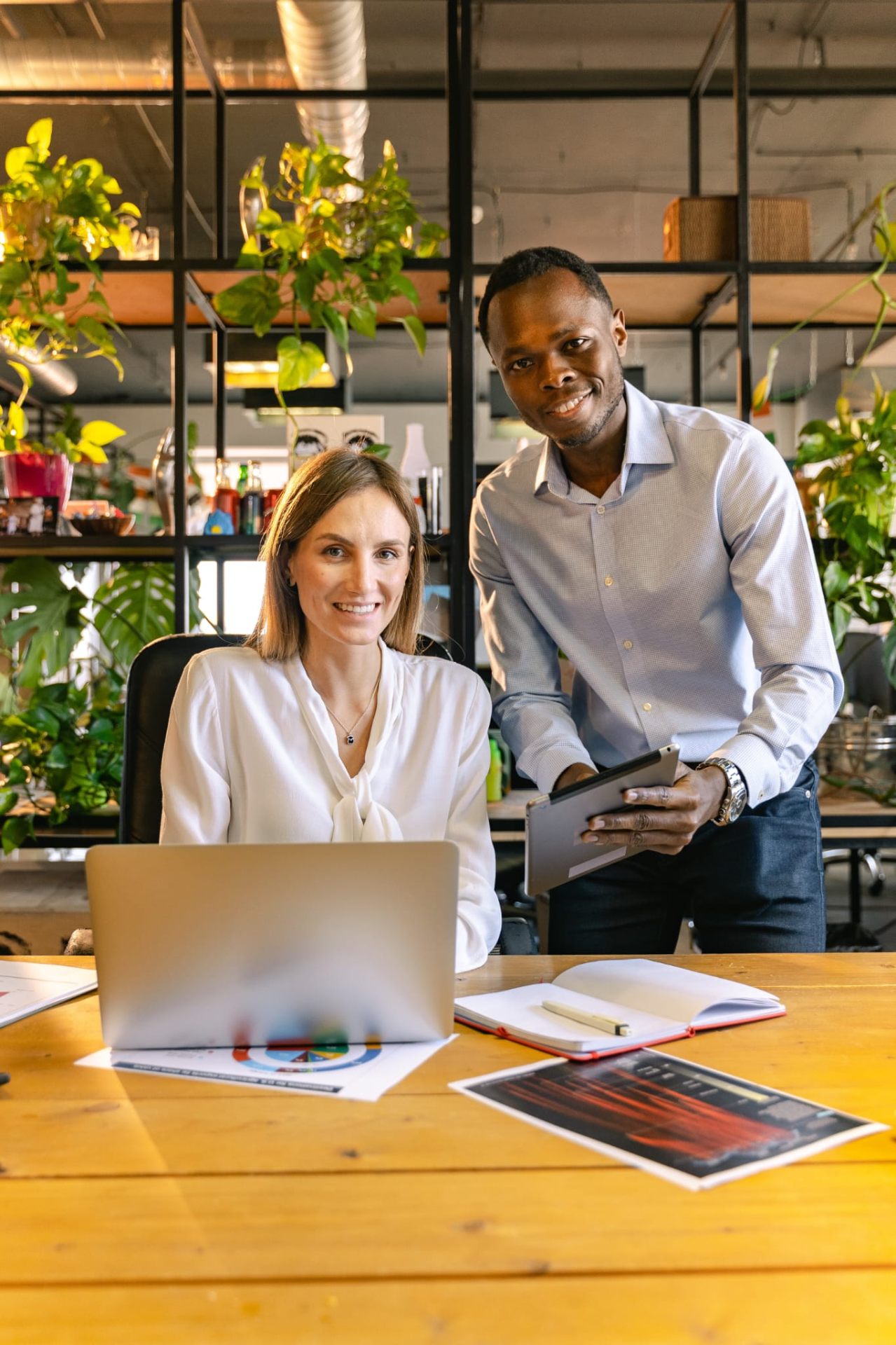 Two Bedfordshire small business owners reviewing their online listing on a laptop